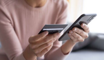 Woman with smartphone and credit card