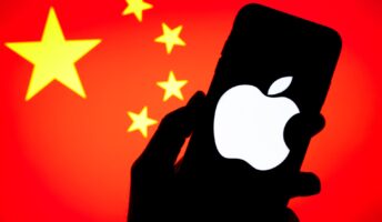 silhouette of hand holding a iPhone in front on a China flag