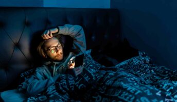 Man on phone in bed