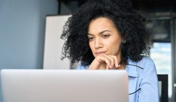 Professional worker looking at laptop