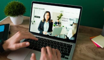 Professional using a website builder at their desk