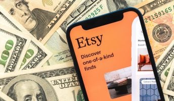 Etsy logo on top of US dollars