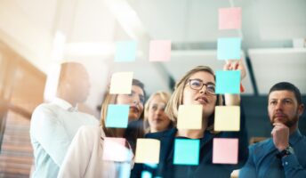 Employees collaborating with post-it notes
