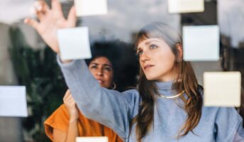 Women looking at post it note