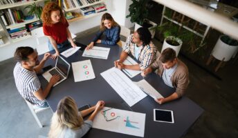 Employees sat round a take in a startup