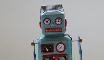 A confused looking robot against a neutral background