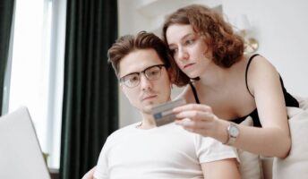A young couple-spending with a credit card