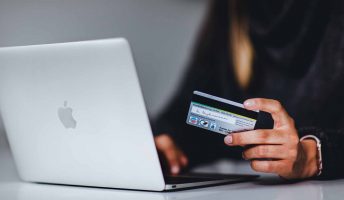 woman with credit card using laptop