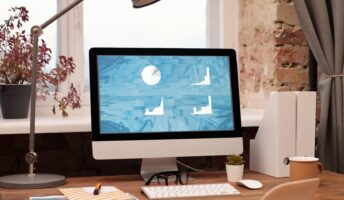 Laptop on a desk, displaying website.