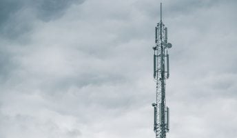 mobile network tower grey clouds