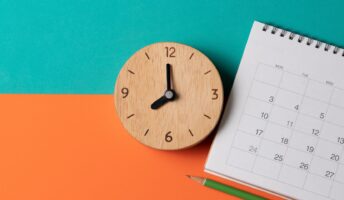 Clock and calendar on colorful background