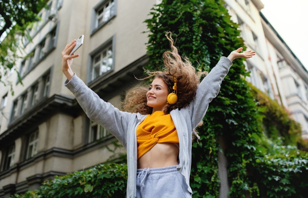 girl dancing in street creating social media content