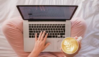 woman at laptop with coffee using Wix